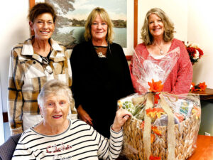 Our drawing winner, Mary Little, seated with FHC staff standing left to right, Linda Clark Executive Director, Kathleen Botelho Tenant Relations Director, and Linda Cain Executive Assistant